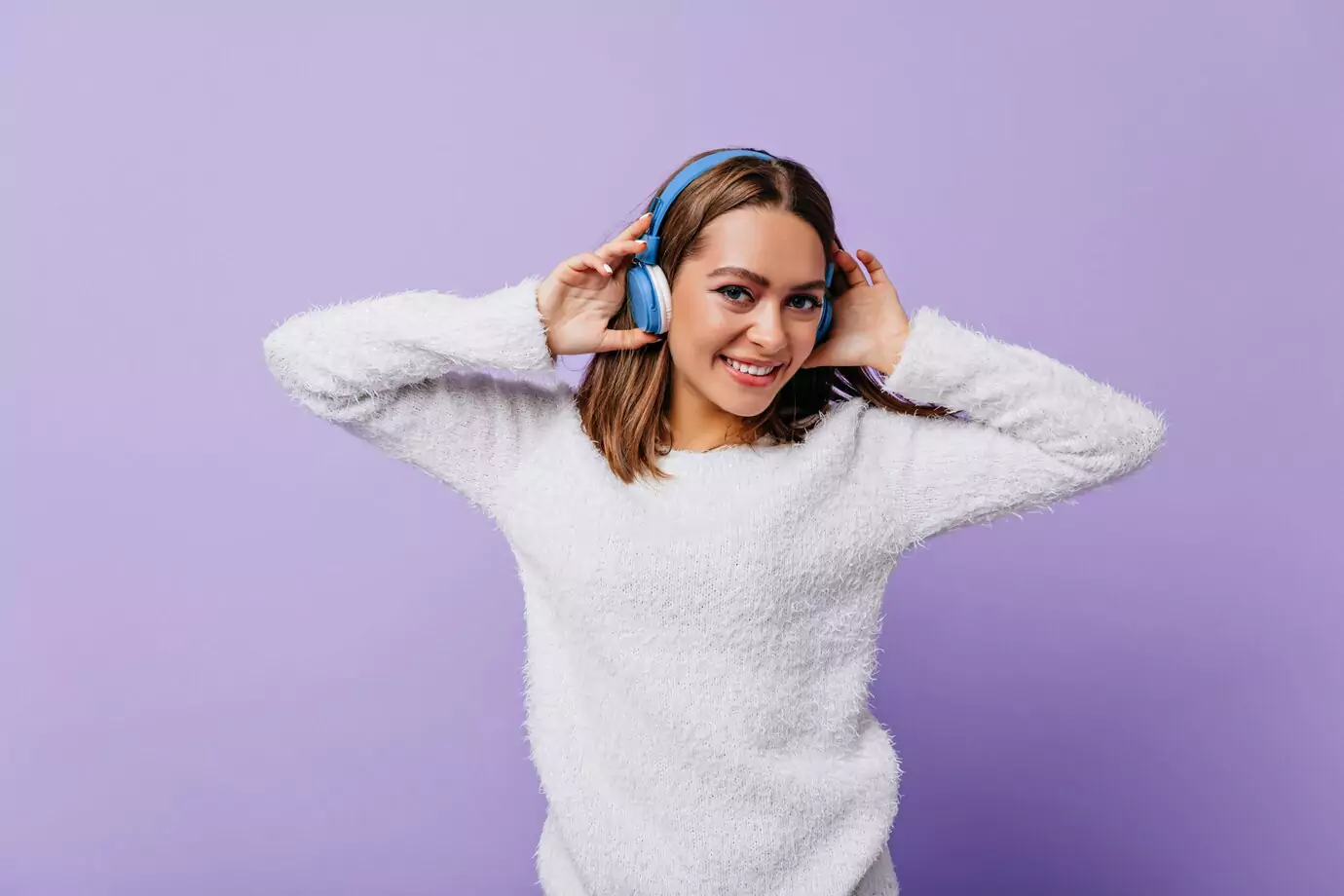 giggling-young-woman-good-mood-cute-touching-her-headphones